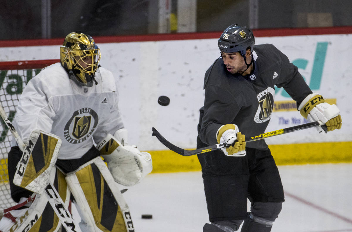Vegas Golden Knights right wing Ryan Reaves (75, right) deflects a shot towards the net and goa ...