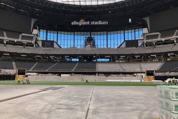 Crews installing the artificial turf that UNLV football will play its home games on in Allegian ...