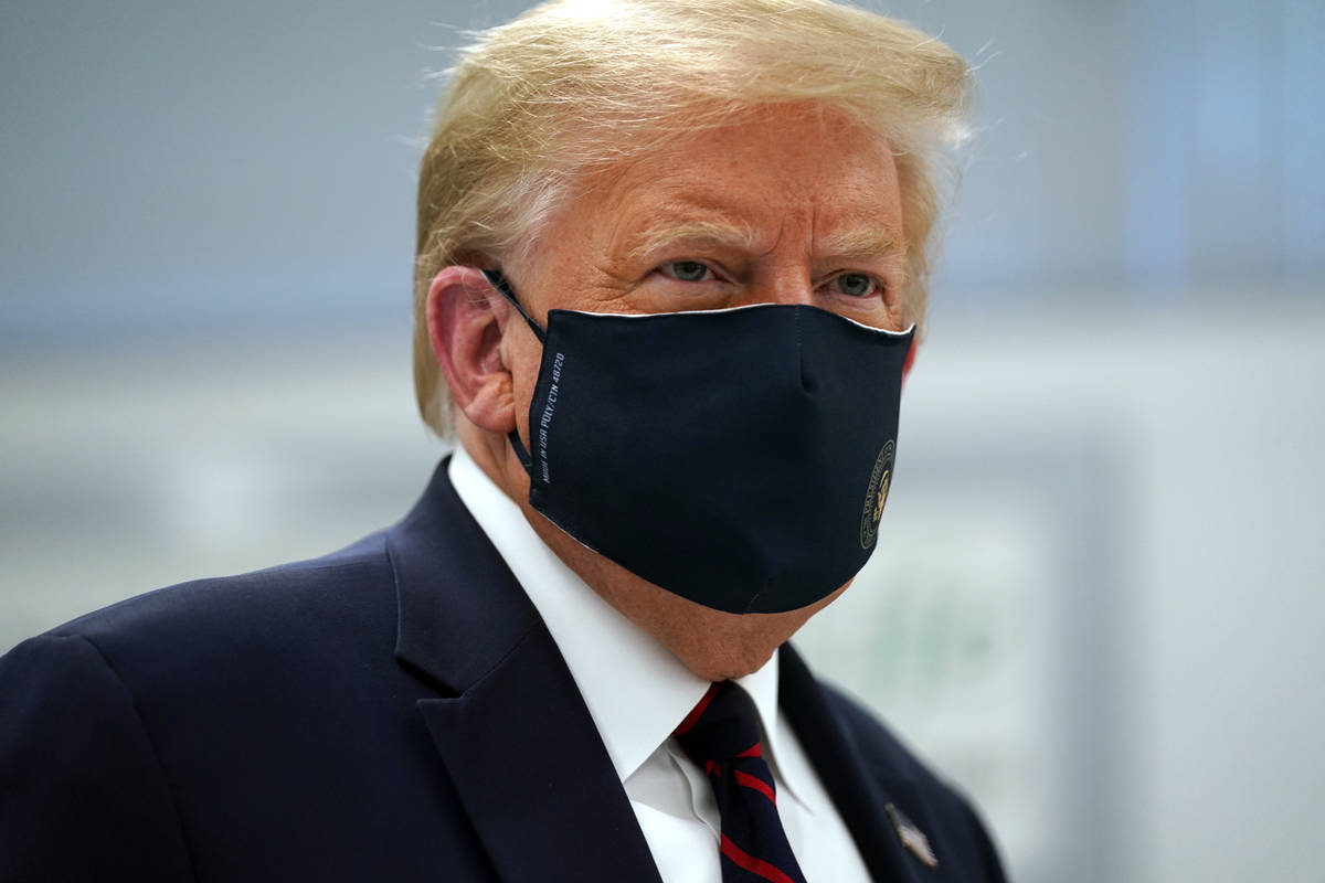 President Donald Trump wears a face mask as he participates in a tour of Bioprocess Innovation ...