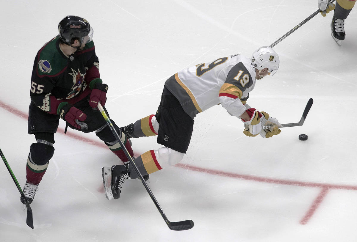 Arizona Coyotes' Jason Demers (55) trips up Vegas Golden Knights' Reilly Smith (19) during the ...