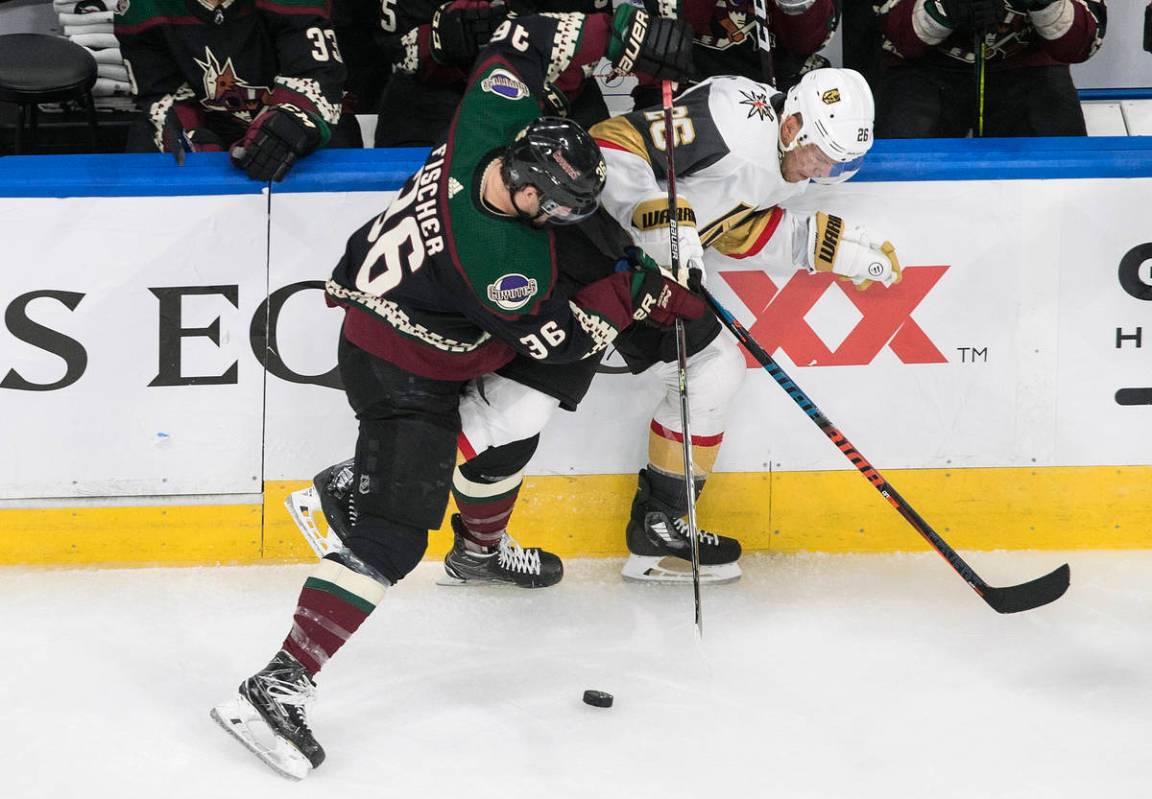 Arizona Coyotes' Christian Fischer (36) checks Vegas Golden Knights' Paul Stastny (26) during t ...