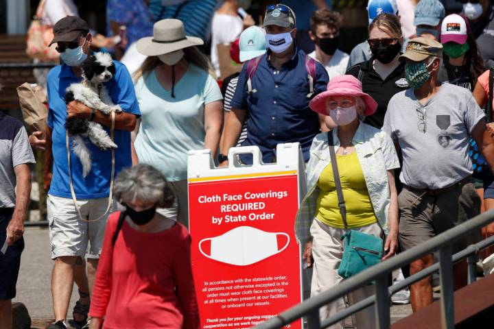 Passengers boards a Casco Bay Lines ferry bound for Peaks Island, Thursday, July 30, 2020, in P ...