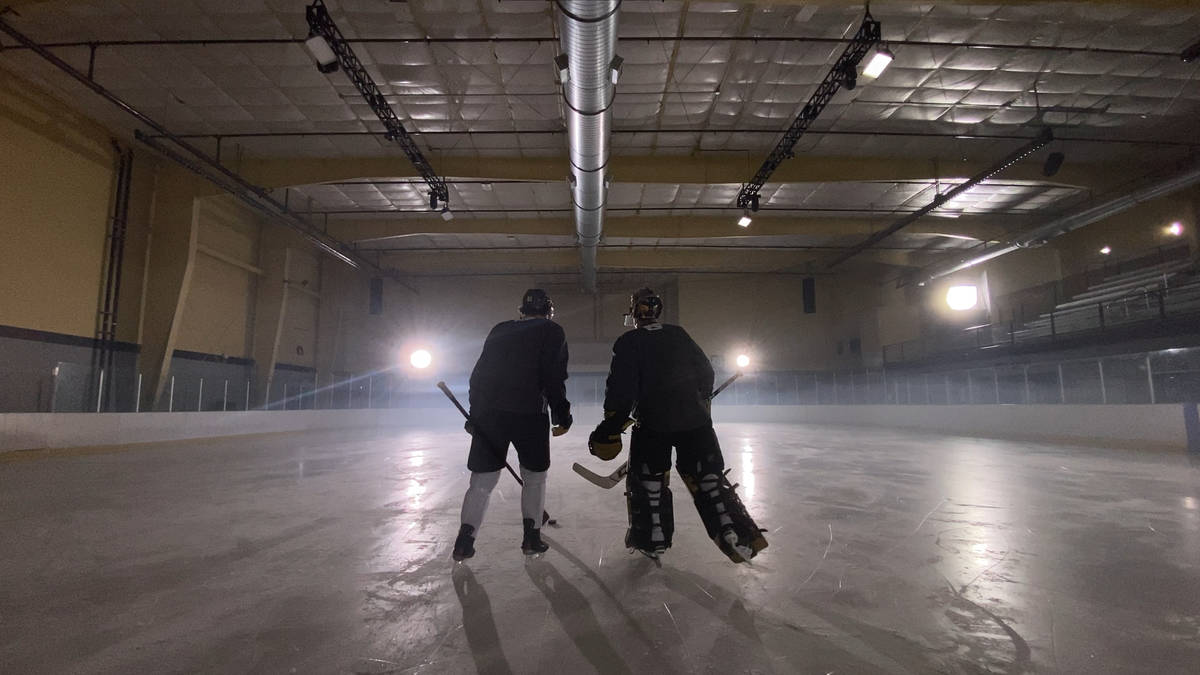 Golden Knights right wing Mark Stone and goaltender Marc-Andre Fleury skate together while film ...