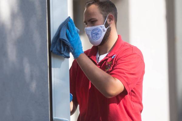 A member of the legislative janitorial crew cleans on Friday, July 31, 2020 during the first da ...