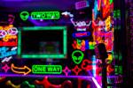 A door handle featuring a microphone in a room filled with neon at Kamu Karaoke at the Grand Ca ...