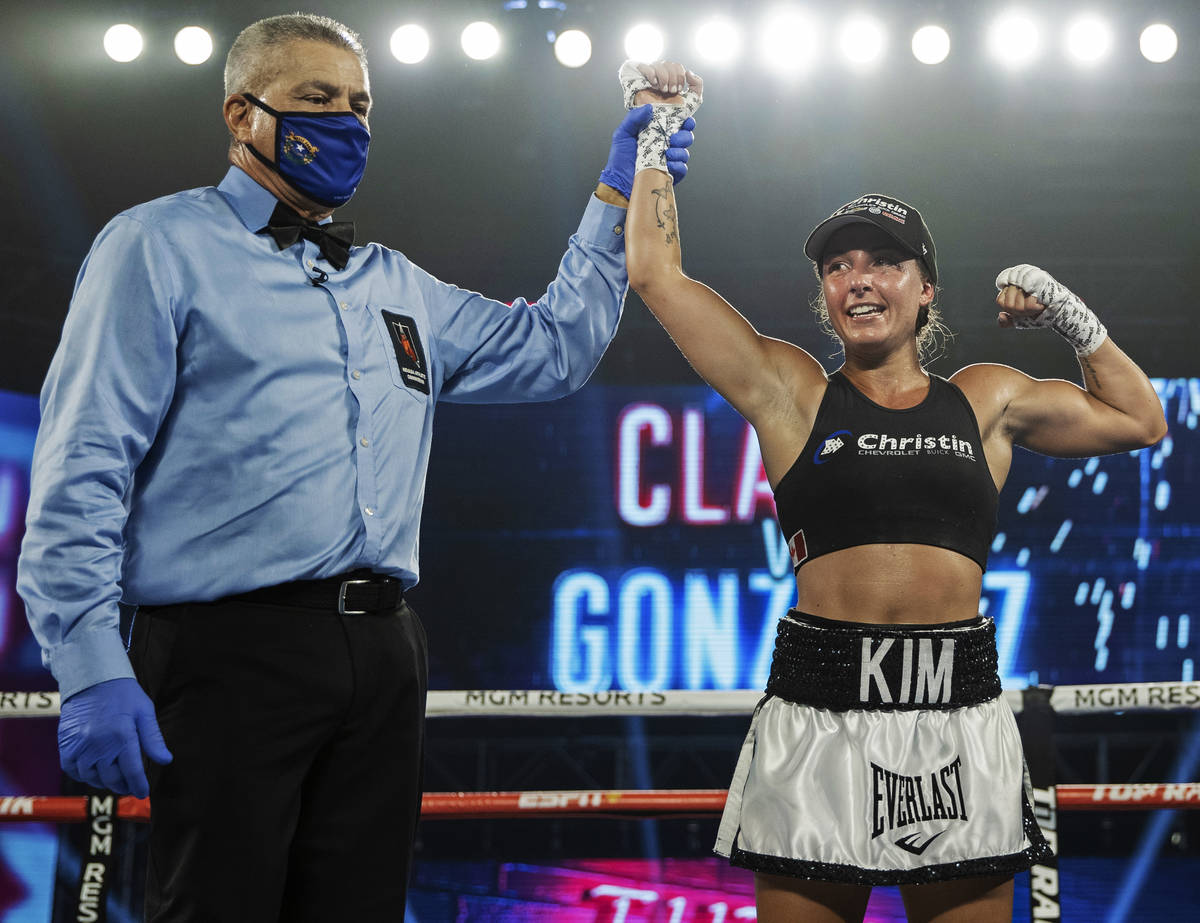 Kim Clavel, right, celebrates after beating Natalie Gonzalez in their light flyweight fight dur ...