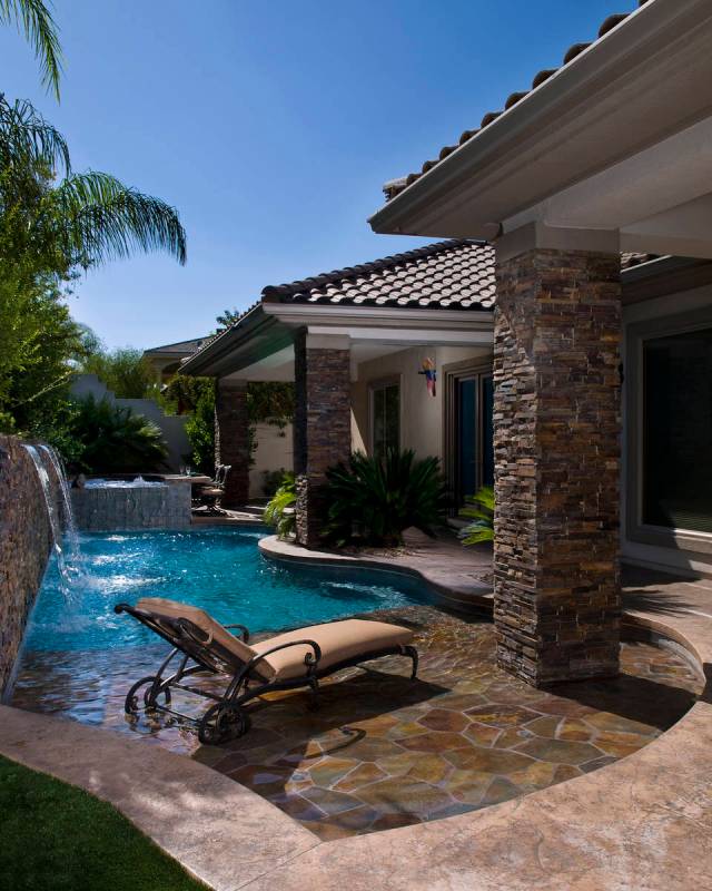 This small backyard pool has a water feature, wet deck and spa with its own bar. (Premier Pools ...