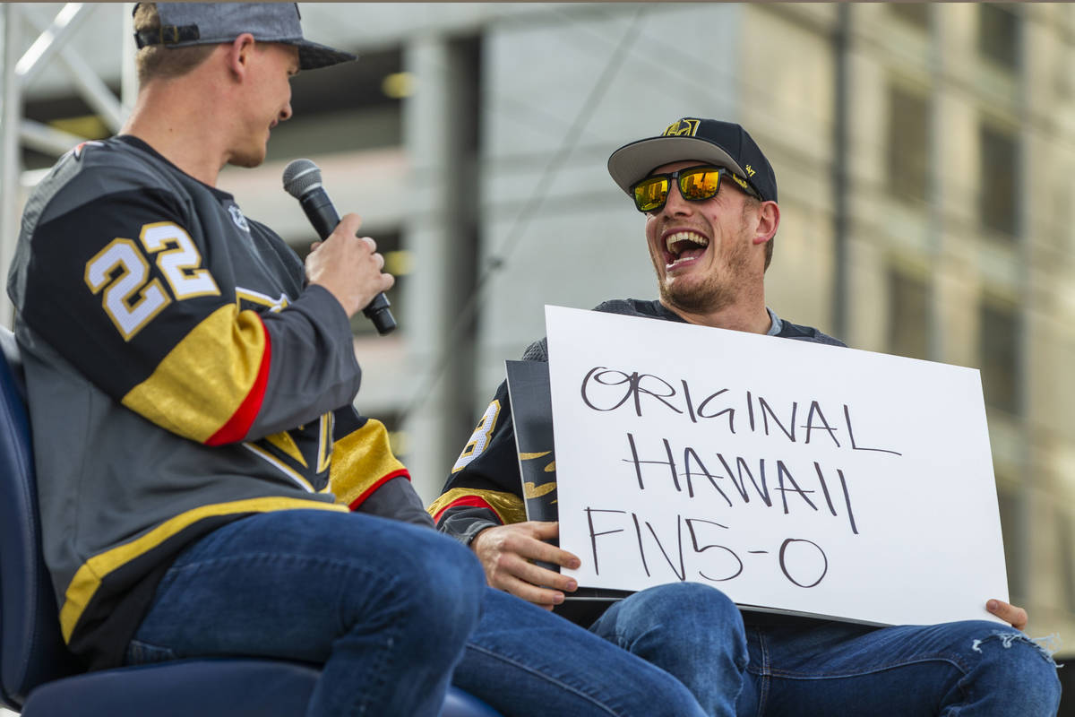 Vegas Golden Knights players Nick Holden, left, and Nate Schmidt laugh as they play a round of ...