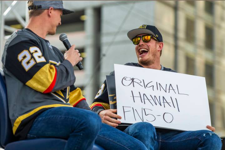 Vegas Golden Knights players Nick Holden, left, and Nate Schmidt laugh as they play a round of ...