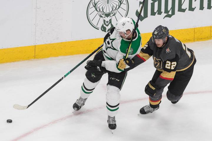 Dallas Stars' Radek Faksa (12) and Vegas Golden Knights' Nick Holden (22) battle for the puck d ...