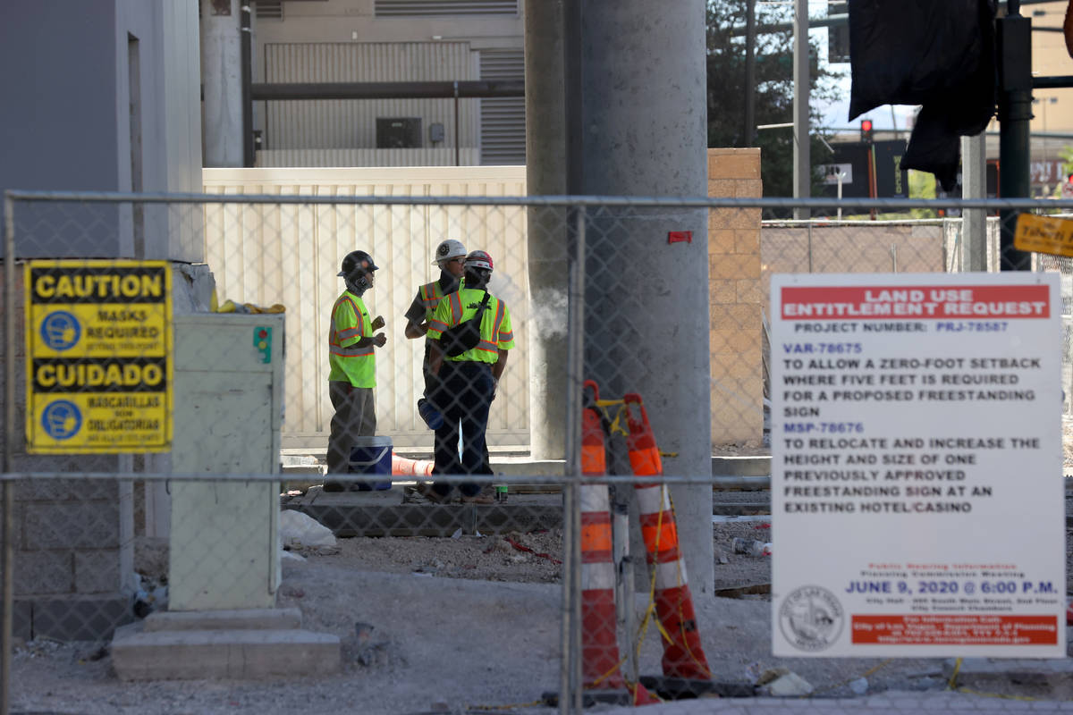 Construction workers at the Gallery Tower expansion, right, at the Downtown Grand in Las Vegas ...