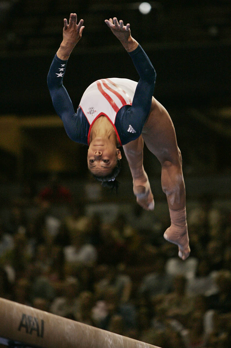 Tasha Schwikert, of Las Vegas, performs on the balance beam during preliminaries at the U.S. Ol ...