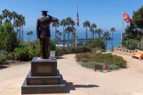 Former San Clemente Mayor Wayne Eggleston lowers the U.S. flag to half-staff at Park Semper Fi ...