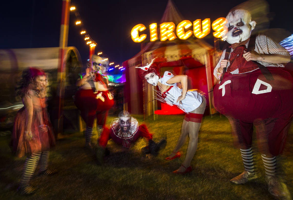 Costumed characters pose during the first day of the Electric Daisy Carnival at the Las Vegas M ...