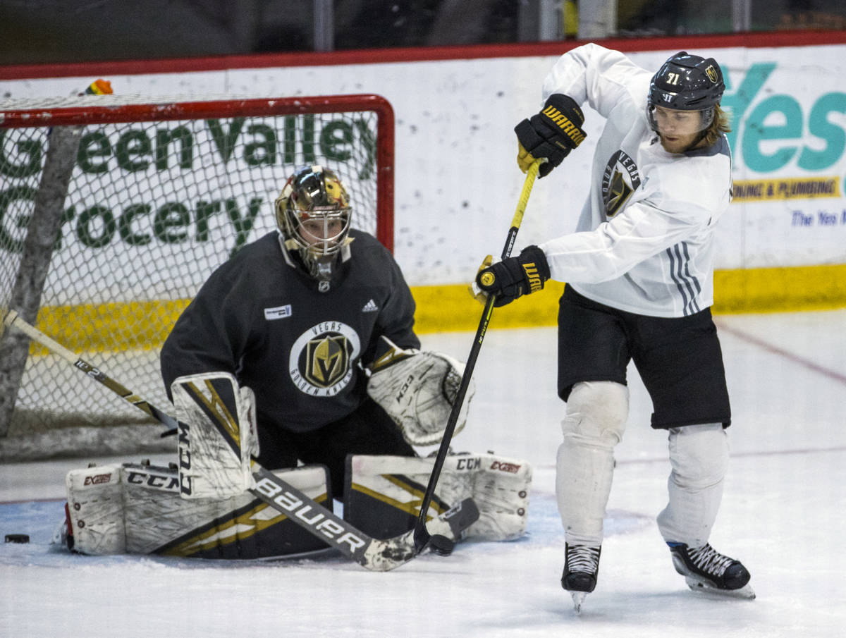 Vegas Golden Knights center William Karlsson (71, right) deflects a shot towards the net and go ...