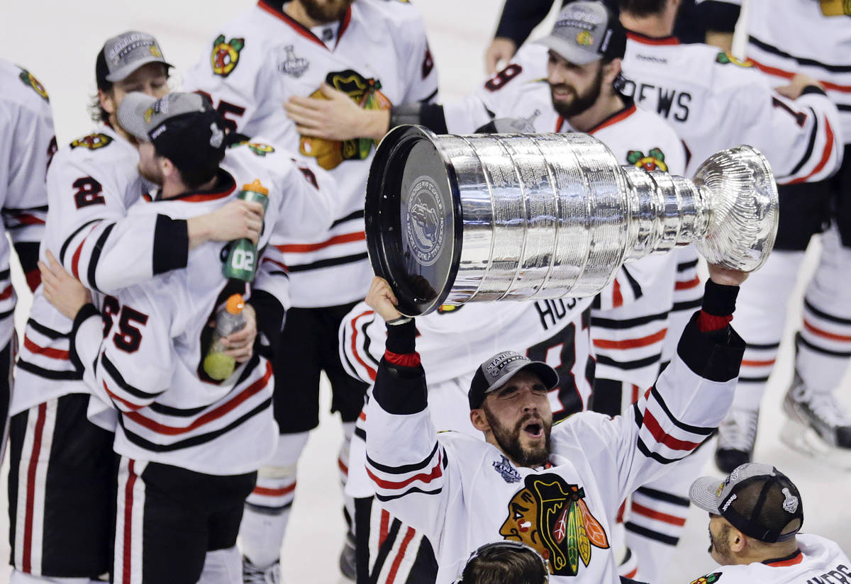 In this June 24, 2013, file photo, Chicago Blackhawks defenseman Michal Rozsival hoists the Sta ...