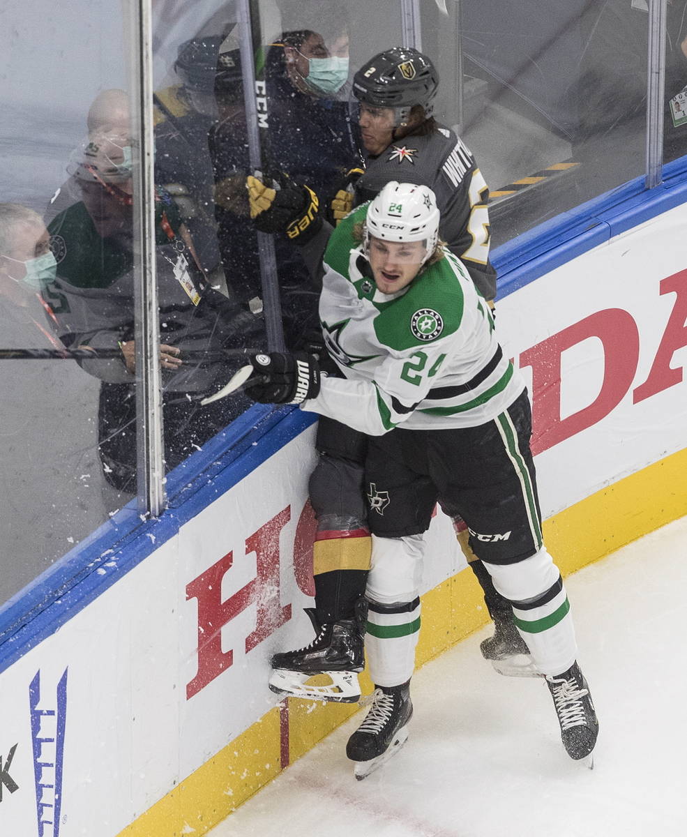 Dallas Stars' Roope Hintz (24) checks Vegas Golden Knights' Zach Whitecloud (2) during the firs ...