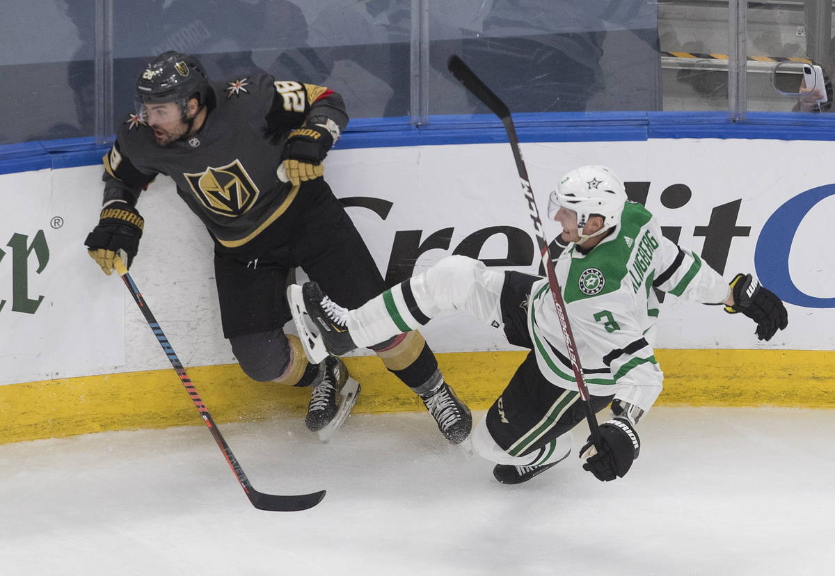 Dallas Stars' John Klingberg (3) is checked by Vegas Golden Knights' William Carrier (28) durin ...