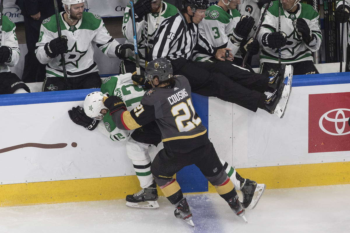 Dallas Stars' Radek Faksa (12) is checked by Vegas Golden Knights' Nick Cousins (21) during the ...