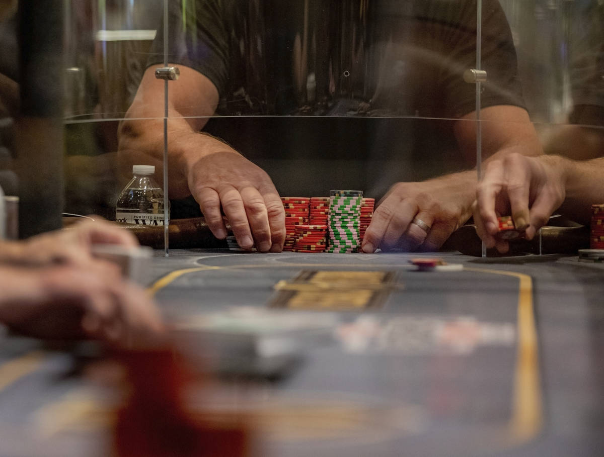 An eight-handed game is played using plexiglass dividers between the players in the Red Rock Re ...