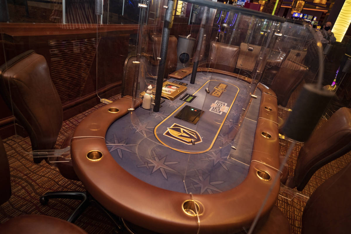 Plexiglass dividers are seen between the seats for Eight-handed games, in the Red Rock Resort p ...