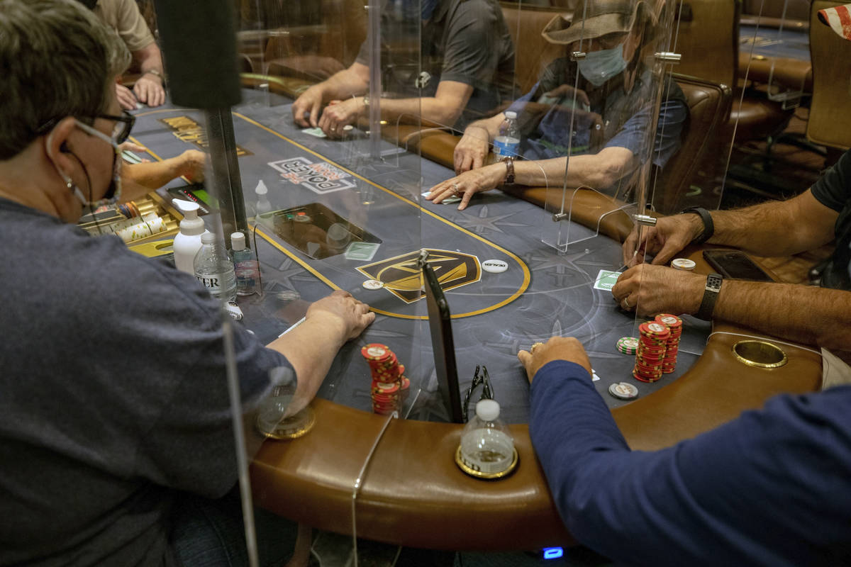 An eight-handed game is played using plexiglass dividers between the players in the Red Rock Re ...