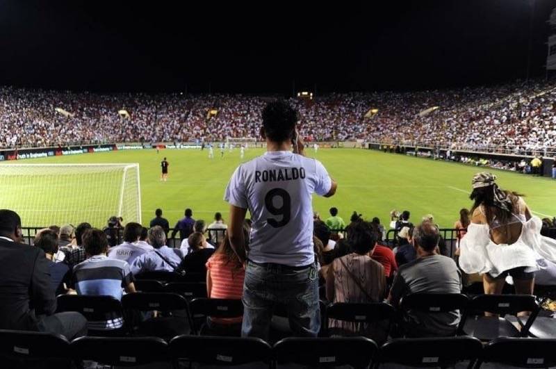 A Cristiano Ronaldo fan takes a photo from the end zone seats during the the Aug. 5, 2012 frien ...