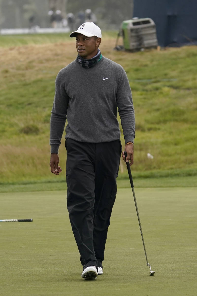 Tiger Woods walks on the putting green during practice for the PGA Championship golf tournament ...