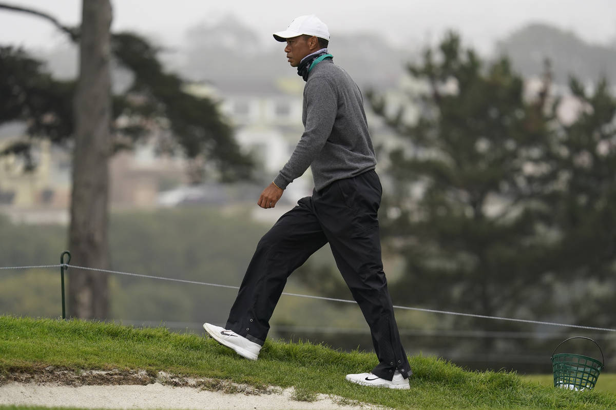 Tiger Woods walks along a green during practice for the PGA Championship golf tournament at TPC ...