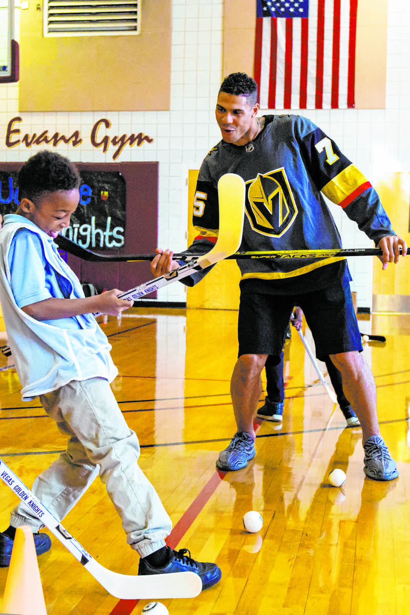Golden Knights forward Ryan Reaves shows Javon Williams, 9, how to celebrate after scoring a go ...