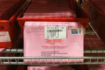 In this Oct. 22, 2018, file photo, mail-in ballots are placed in bins to be processed after arr ...