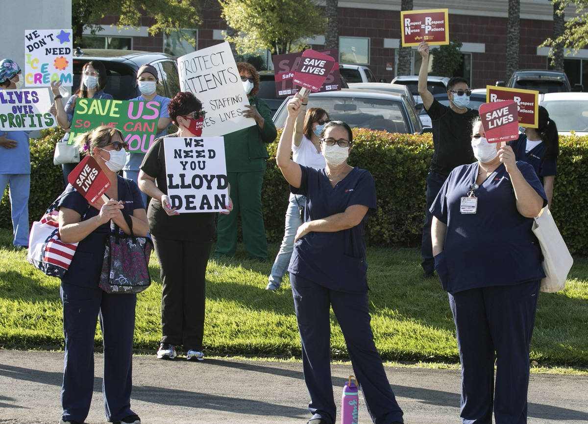 Registered Nurses Zully Hernandez, center and Aariana Kovacs, right, picket outside of St. Rose ...