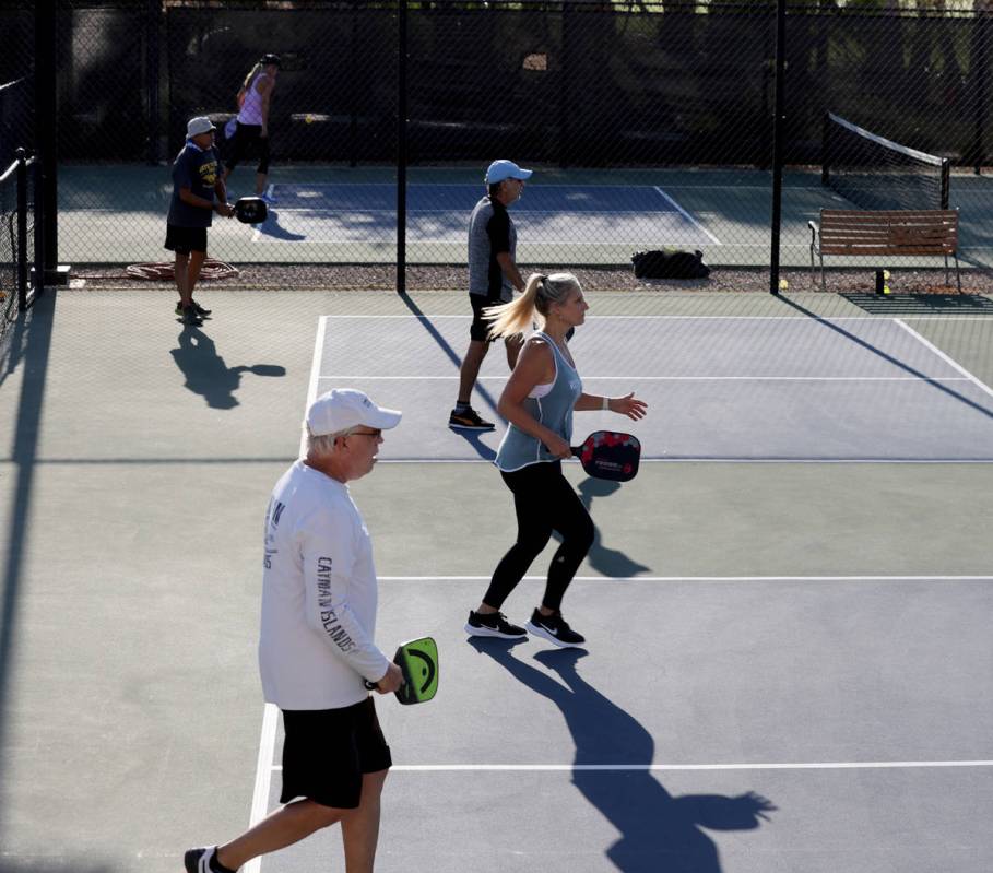 Bob Preusser, left, and Jen Buell, both of Henderson, play pickleball early morning to beat the ...