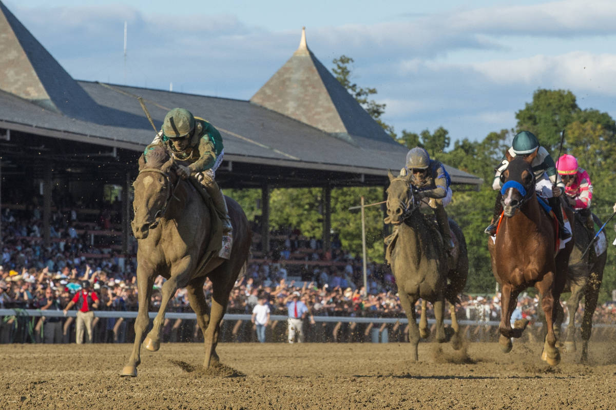 In this Aug. 24, 2019, file photo, Code of Honor, left, with jockey John Velazquez, leads the f ...