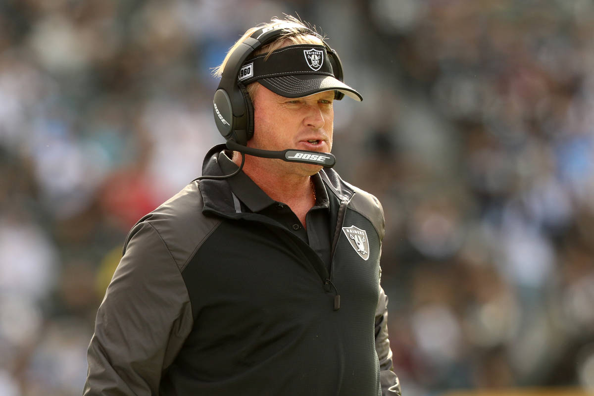 Oakland Raiders head coach Jon Gruden walks the sideline during the first half of an NFL game a ...