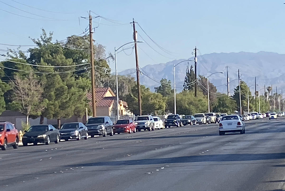 A food distribution for Las Vegas families in need prompted a mile-plus-long line of motorists ...