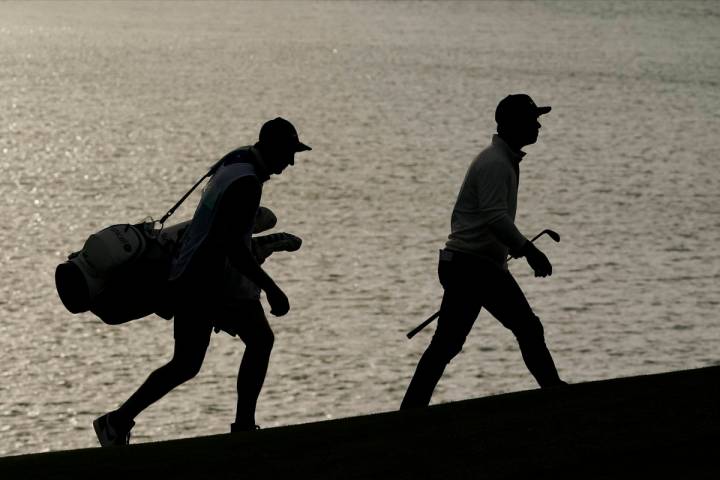 Paul Casey and his caddie walks to the 18th green during the first round of the PGA Championshi ...