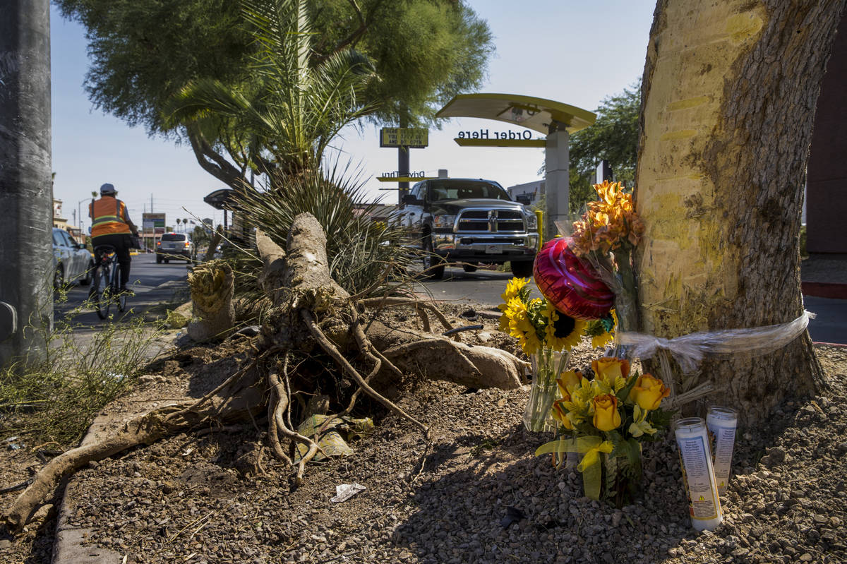 A small memorial sits near downed tree limbs where two teenage girls were struck and killed by ...