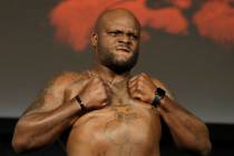 Derrick Lewis reacts while posing atop a scale prior to his heavyweight mixed martial arts bout ...