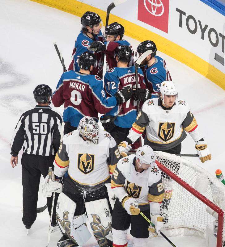 Colorado Avalanche players, rear, celebrate a goal during the second period of an NHL hockey qu ...