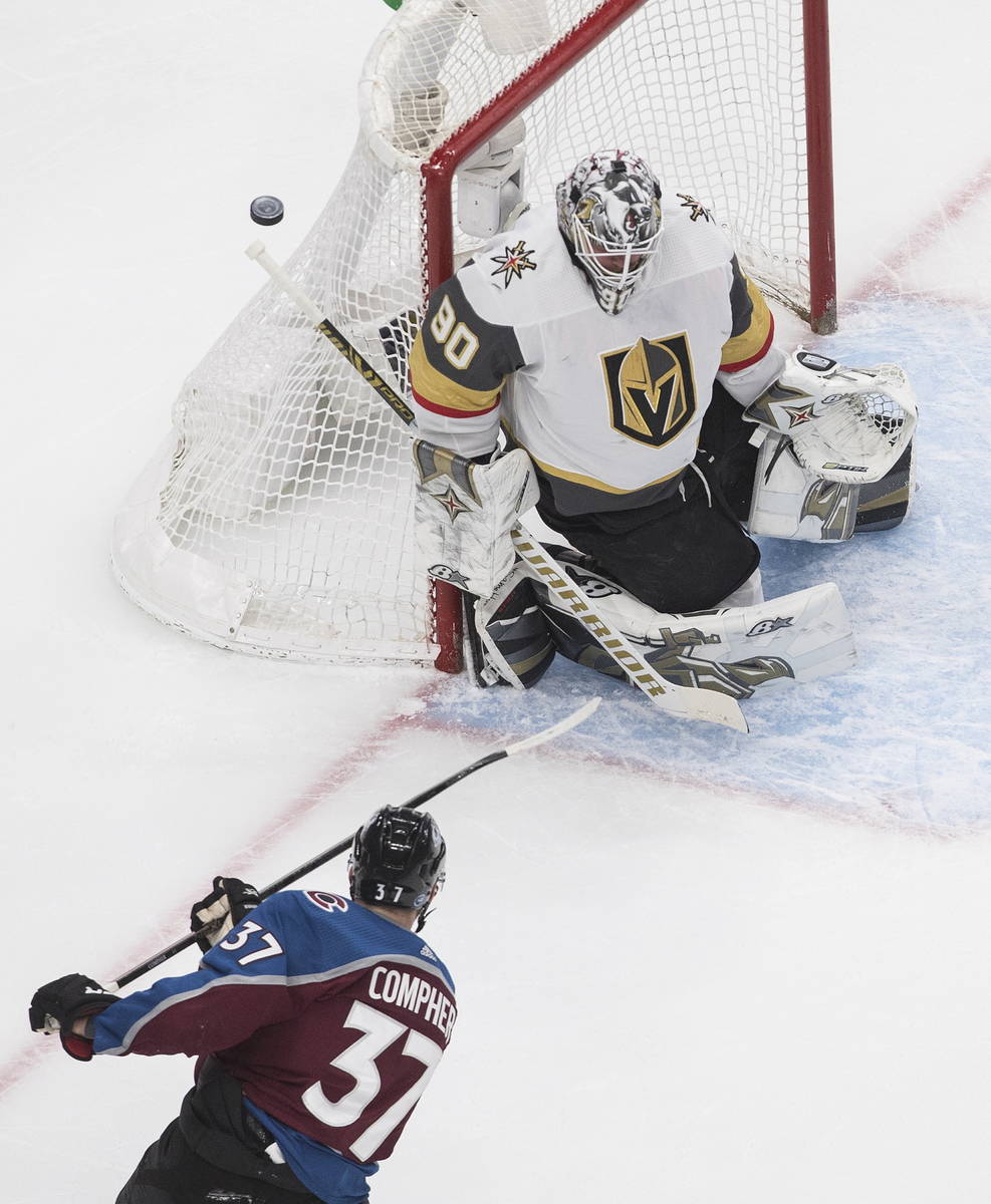 Colorado Avalanche's J.T. Compher (37) is stopped by Vegas Golden Knights goalie Robin Lehner ( ...