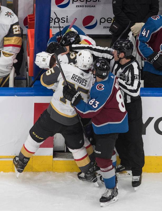 Colorado Avalanche and the Vegas Golden Knights players mix it up during the third period of an ...