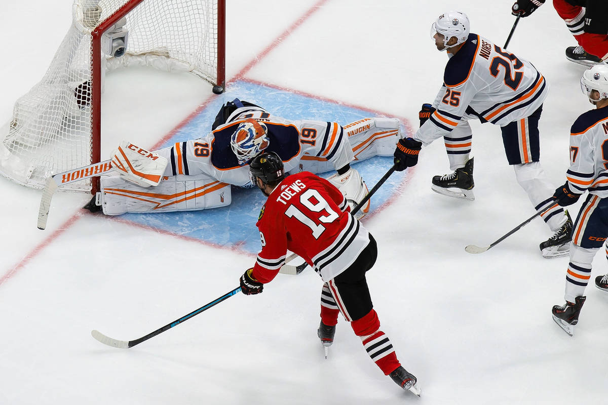 Edmonton Oilers goaltender Mikko Koskinen (19) makes a save against Chicago Blackhawks' Jonatha ...