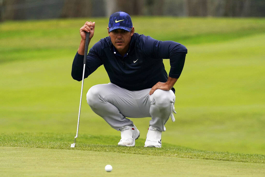 Brooks Koepka lines up a putt on the 13th hole during the third round of the PGA Championship g ...