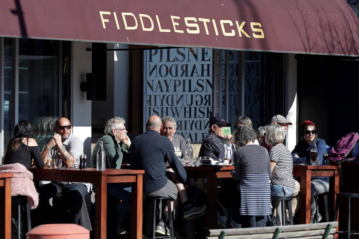 Customers at a cafe enjoy lunch in the sunshine in Christchurch, New Zealand, Sunday, Aug. 9, 2 ...