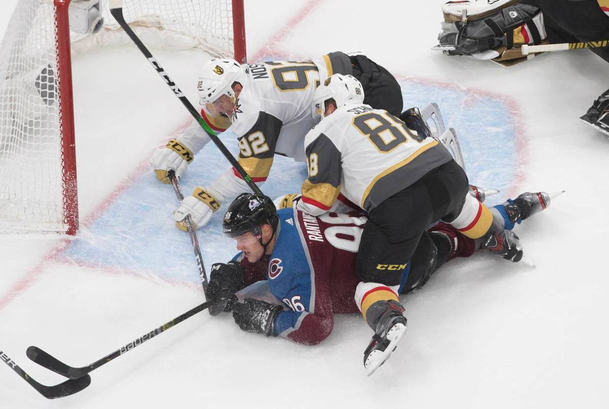 Colorado Avalanche's Mikko Rantanen (96) is taken down by Vegas Golden Knights' Tomas Nosek (92 ...