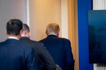 President Donald Trump leaves the James Brady Press Briefing Room by a member of the Secret Ser ...
