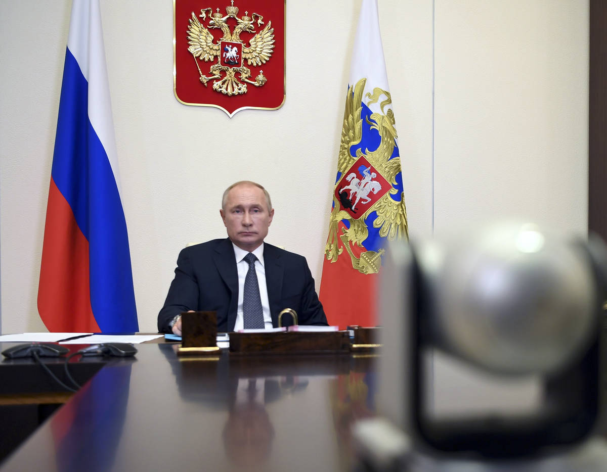 Russian President Vladimir Putin attends a cabinet meeting at the Novo-Ogaryovo residence outsi ...