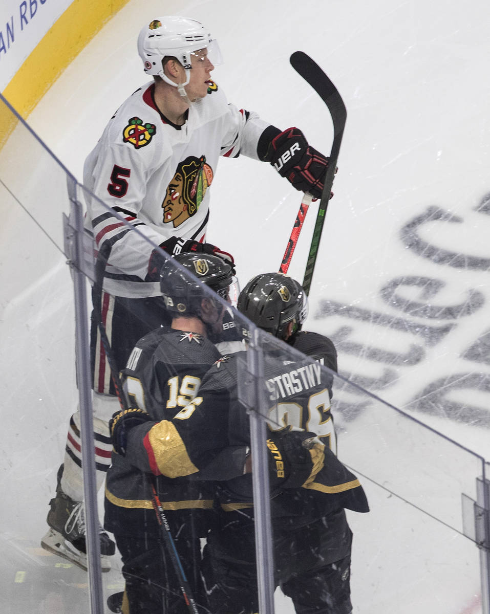 Chicago Blackhawks' Connor Murphy (5) skates by as Vegas Golden Knights' Reilly Smith (19) and ...