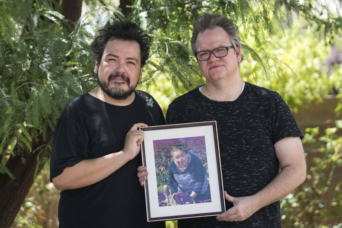 Isaias Urrabazo, left, and his husband, Steven Fehr, hold a photo of Maria Urrabazo, Isaias&#x2 ...